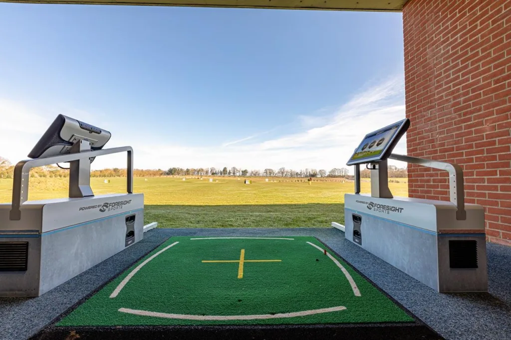 Golf practice area with technology screens